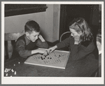 Boy and girl playing Chinese checkers. Eufaula, Oklahoma