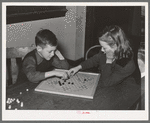 Boy and girl playing Chinese checkers. Eufaula, Oklahoma