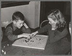 Boy and girl playing Chinese checkers. Eufaula, Oklahoma