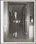 Wife of Jaycee member bringing food to the buffet supper at the high school. Eufaula, Oklahoma. See general caption 25