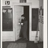 Elderly farm woman arriving at pie supper with her pie which will be sold at auction. Muskogee County, Oklahoma. See general caption number 24