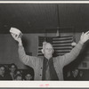 Colonel Lilly auctioning off a piece of cake at pie supper in Muskogee, Oklahoma. See general caption number 24