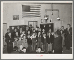 Schoolchildren, directed by their music teacher, sing at the pie supper. McIntosh County, Oklahoma. See general caption number 24