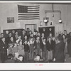 Schoolchildren, directed by their music teacher, sing at the pie supper. McIntosh County, Oklahoma. See general caption number 24