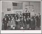 Schoolchildren, directed by their music teacher, sing at the pie supper. McIntosh County, Oklahoma. See general caption number 24