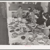 Arranging food on table at buffet supper of the Jaycees at Eufaula, Oklahoma. See general caption number 25