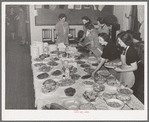 Arranging food on table at buffet supper of the Jaycees at Eufaula, Oklahoma. See general caption number 25