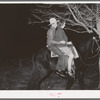 Farm boy and girl riding home after the play party. McIntosh County, Oklahoma. See general caption number 26