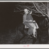 Farm boy and girl riding home after the play party. McIntosh County, Oklahoma. See general caption number 26