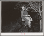 Farm boy and girl riding home after the play party. McIntosh County, Oklahoma. See general caption number 26