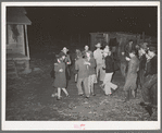Playing a swing game in the yard. Play party in McIntosh County, Oklahoma. See general caption number 26
