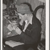 Farm boy rolling a cigarette. Play party in McIntosh County, Oklahoma. See general caption number 26