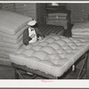 Tufting a mattress. Mattress factory, San Angelo, Texas