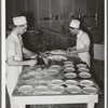 Making and putting pie crusts into pie pans. Bakery, San Angelo, Texas