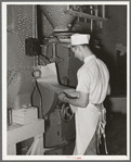 Looking over the order list for baking. Bakery, San Angelo, Texas