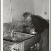 Farmer cleaning out milk can. Creamery, San Angelo, Texas