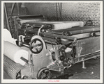 Machine for making cotton bats used for filling mattresses. Mattress factory, San Angelo, Texas