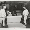 Unrolling cotton batting. Mattress factory, San Angelo, Texas