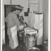 Straining milk at large dairy in Tom Green County, Texas