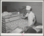 Throwing balls of dough onto rack where they will be shaped into loaves, allowed to rise, and then baked. Bakery, San Angelo, Texas