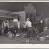 Trucker and buyer at early morning farmers market. San Angelo, Texas