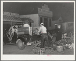 Trucker and buyer at early morning farmers market. San Angelo, Texas