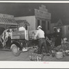 Trucker and buyer at early morning farmers market. San Angelo, Texas