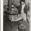 Daughter of Pomp Hall, Negro tenant farmer, taking ashes out of stove before building fire in the morning. Creek County, Oklahoma