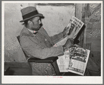 Pomp Hall, Negro tenant farmer, reading newspaper to which he subscribes. Creek County, Oklahoma