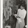 Wife of Pomp Hall, Negro tenant farmer, cleaning lamp chimneys. Creek County, Oklahoma