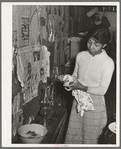 Wife of Pomp Hall, Negro tenant farmer, cleaning lamp chimneys. Creek County, Oklahoma