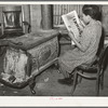 Daughter of Pomp Hall, tenant farmer, reading about chickens in farm magazine. She raises chickens as her 4-H Club project. Creek County, Oklahoma