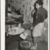 Removing ashes from stove before starting the fire in the early morning. Home of Pomp Hall, Negro tenant farmer. Creek County, Oklahoma