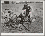 Pomp Hall, Negro tenant farmer, adjusting his cultivator so it will be in readiness for the spring planting. Creek County, Oklahoma