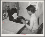 Wife of Pomp Hall, Negro tenant farmer, writing on typewriter. Through union activities this family has developed a desire for higher education. This typewriter is to them a symbol of that education and as such is the most prized family possession