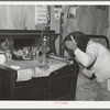 Wife of Pomp Hall, Negro tenant farmer, combing her hair in the morning. Creek County, Oklahoma