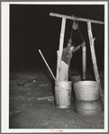 Drawing water from the well in the early morning. Farm of Pomp Hall, Negro tenant farmer. Creek County, Oklahoma