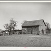 Barn and vegetable stands of Pomp Hall, Negro tenant farmer. During the summer months he sells his produce at this stand on the highway. He also adds to his income by allowing the signs to be painted on his barn which is visible far down the highway. Creek County, Oklahoma