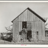 Son of Pomp Hall, Negro tenant farmer, carrying hay into barn to feed mule while his brother pitches down the hay from the loft above. Creek County, Oklahoma