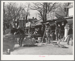 Secondhand row, Oklahoma City, Oklahoma. Oklahoma City seems to have an unusually large number of these cheap secondhand stores, probably because of the floating oil workers and currently shifting populations in surrounding rural areas