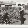Salesman showing walking plow to prospective buyer. Oklahoma City, Oklahoma