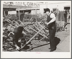 Salesman showing walking plow to prospective buyer. Oklahoma City, Oklahoma