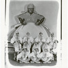 Publicity photograph of chorus showgirls with backdrop image of Aunt Jemima for the stage production Dixie to Broadway