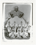 Publicity photograph of chorus showgirls with backdrop image of Aunt Jemima for the stage production Dixie to Broadway