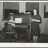 Young lady from nearby college singing at the Jaycee buffet supper and party. Eufaula, Oklahoma. See general caption 25
