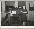 Young lady from nearby college singing at the Jaycee buffet supper and party. Eufaula, Oklahoma. See general caption 25