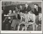 High school coach giving last minute instructions to substitute who is going into the game. Basketball game, Eufaula, Oklahoma