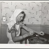 FSA (Farm Security Administration) supervisor giving a demonstration of pressure canning before a group of FSA officials at a district meeting. She is letting off steam from the pressure cooker by opening the steam cock with a spoon. San Angelo, Texas