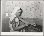 FSA (Farm Security Administration) supervisor giving a demonstration of pressure canning before a group of FSA officials at a district meeting. She is letting off steam from the pressure cooker by opening the steam cock with a spoon. San Angelo, Texas