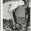 FSA (Farm Security Administration) supervisor giving a demonstration of pressure canning before a group of FSA officials at a district meeting. San Angelo, Texas. She is removing cans from pressure cooker